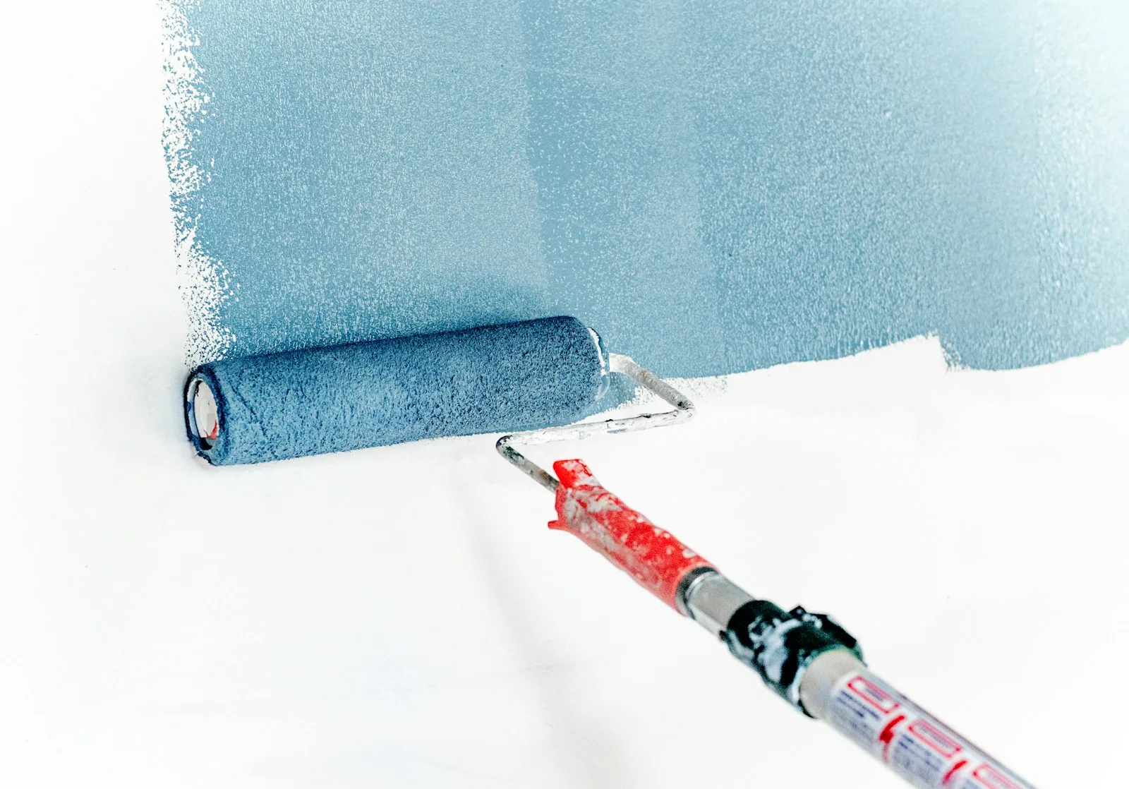 Blue paint and a roller — editorial stock photography, not an Andy project